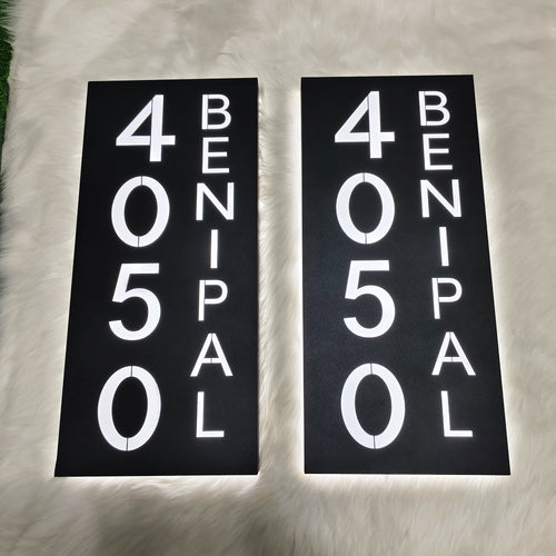 Pair of aluminum LED backlit house number signs in black with glowing white numbers