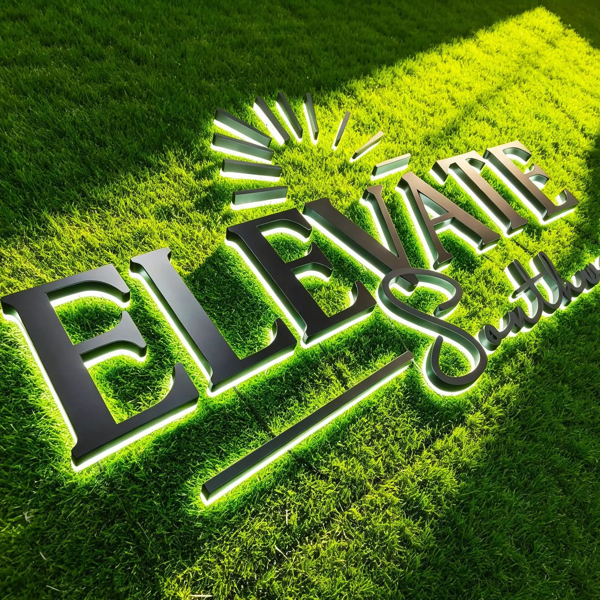LED backlit company logo sign Elevate Southwest with dark metal letters and white halo